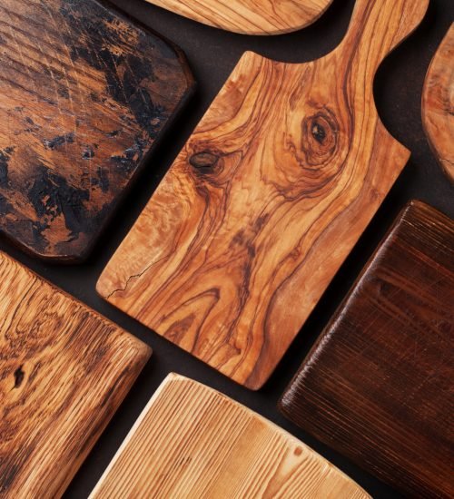 Various cutting boards on stone table. Cooking utensils. Top view
